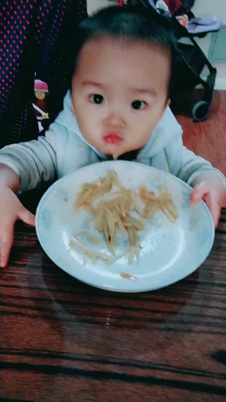 爸爸做了一盘土豆丝,没想到小宝那么爱吃,抱起盘子吃个不停!