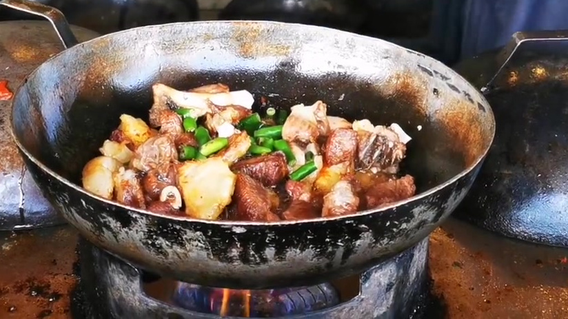 巴基斯坦美食,爆炒羊肉。食材主料是切好的新鲜羊肉块,土豆块。配料是西红柿和小青椒。 炒锅里