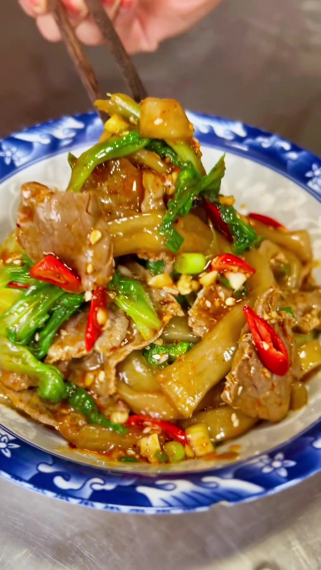 《宽粉拌牛肉》「1」主料:宽粉、牛肉、生菜、小葱、小米椒、大蒜。「2」调料:盐、鸡精、生抽