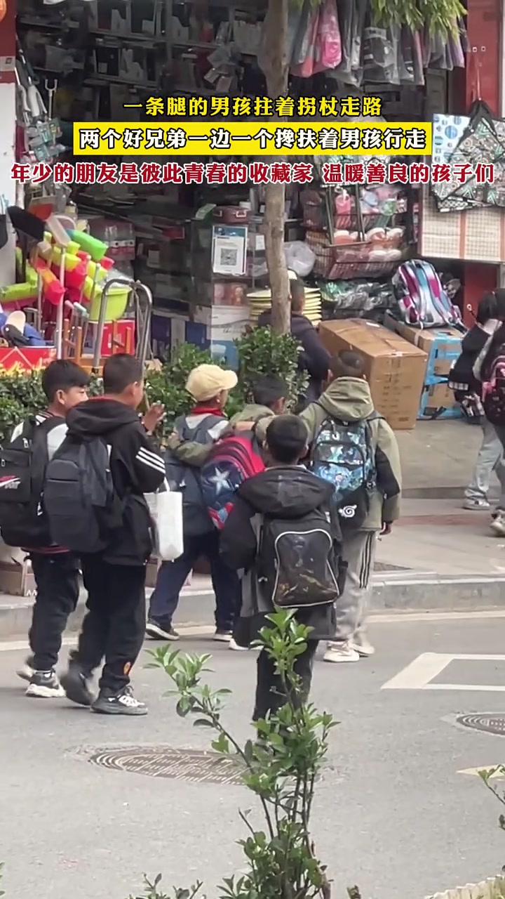 一条腿的男孩拄着拐杖走路两个好兄弟一边一个搀扶着男孩行走